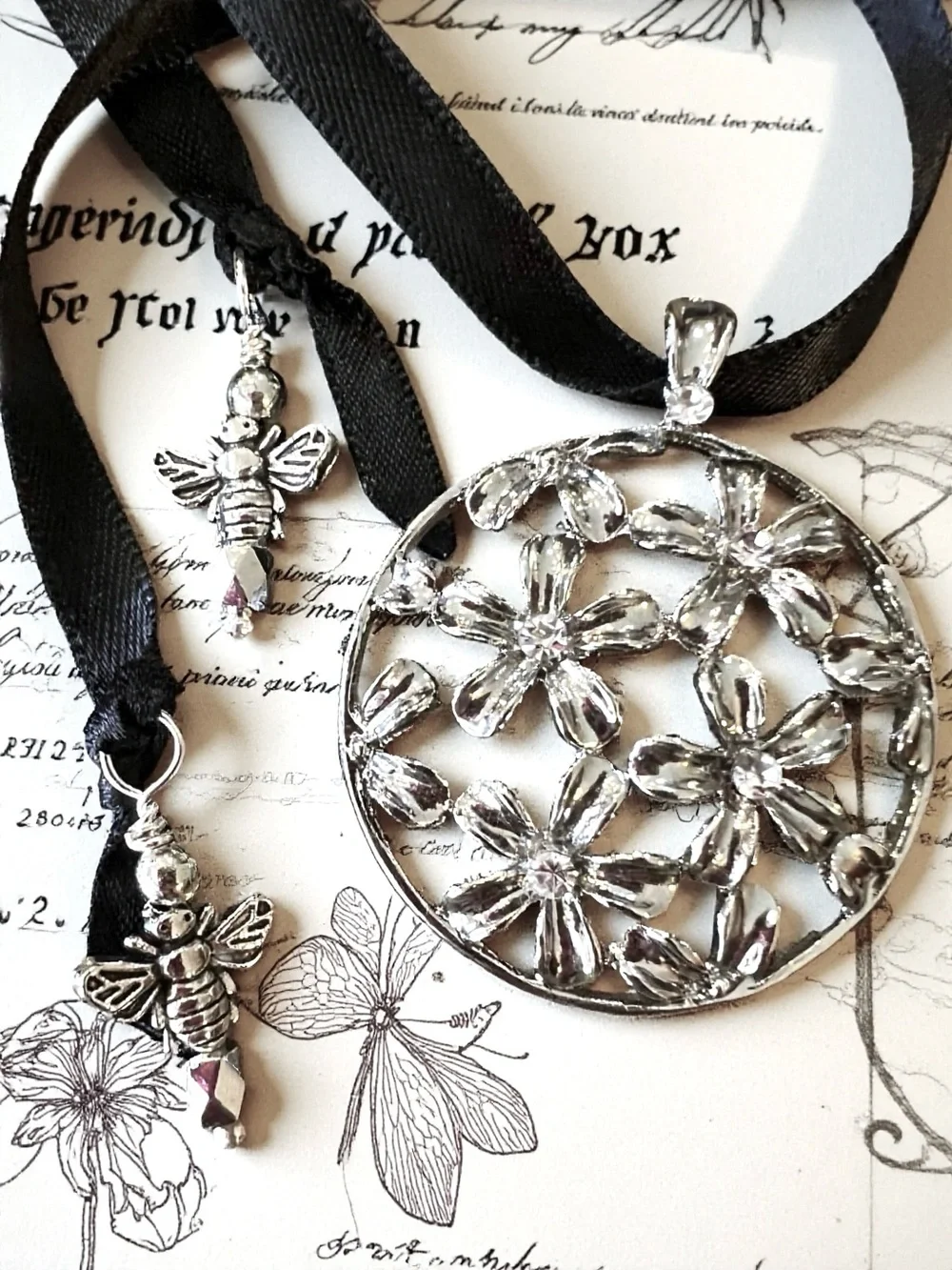 Silver Toned Floral Cutout Pendant Necklace on Black Satin Ribbon